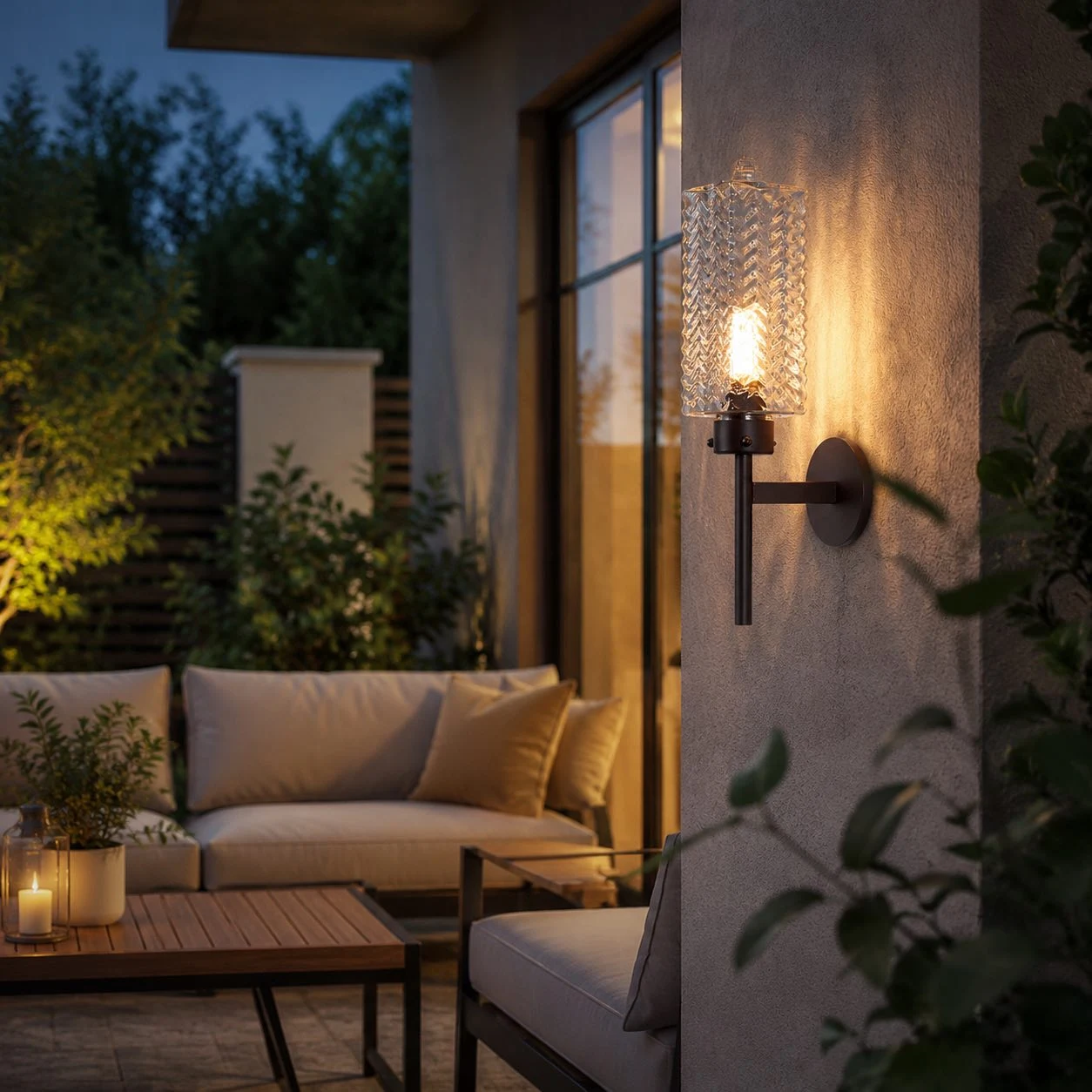 Rippled glass outdoor wall sconce glowing beside seating