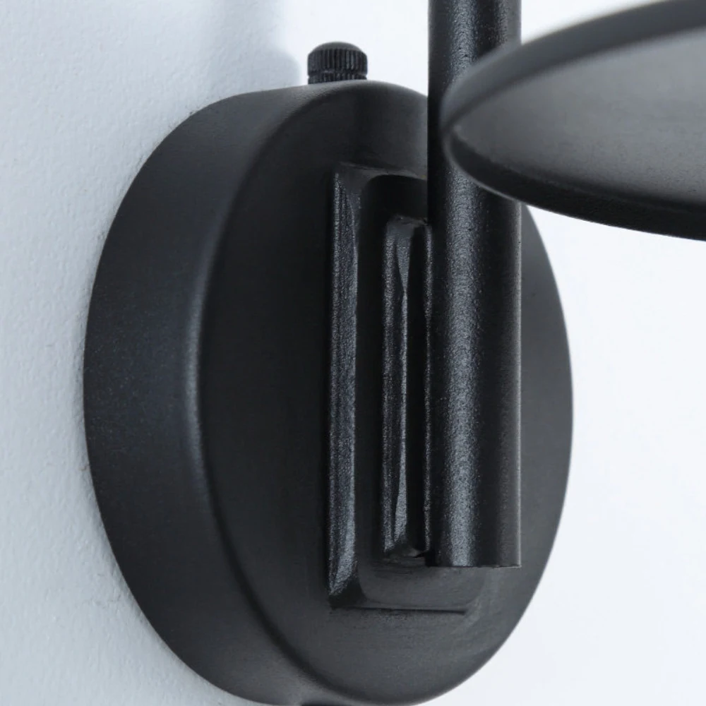Close view of circular wall mount and matte metal finish