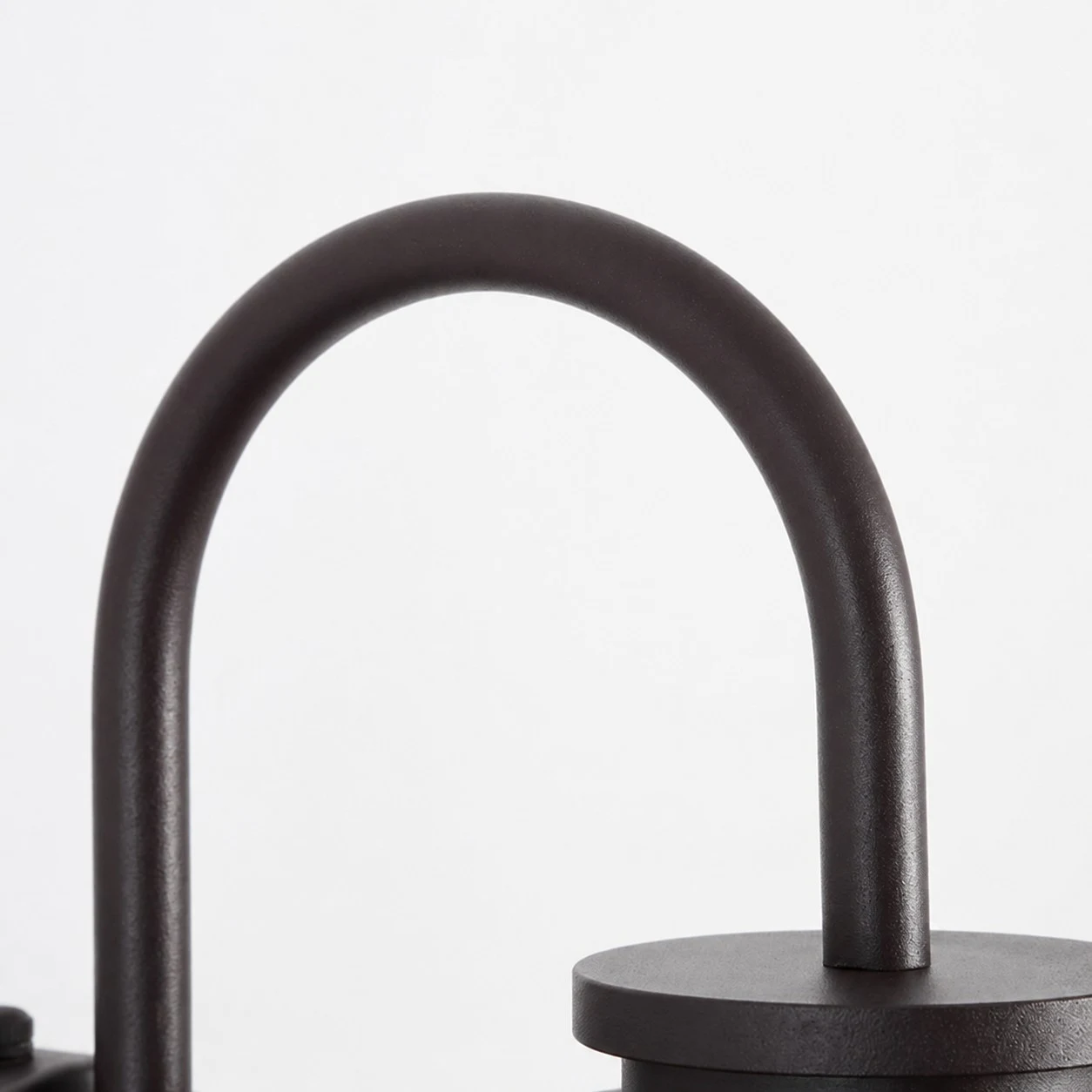 Close view of curved gooseneck metal arm