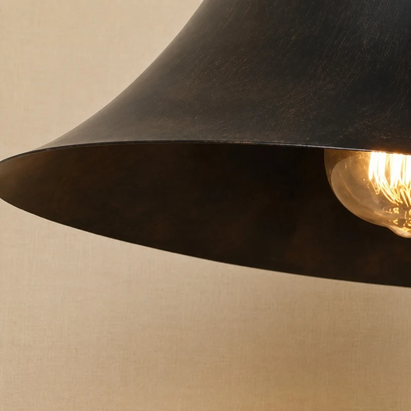 Warm light beneath the open bell shade