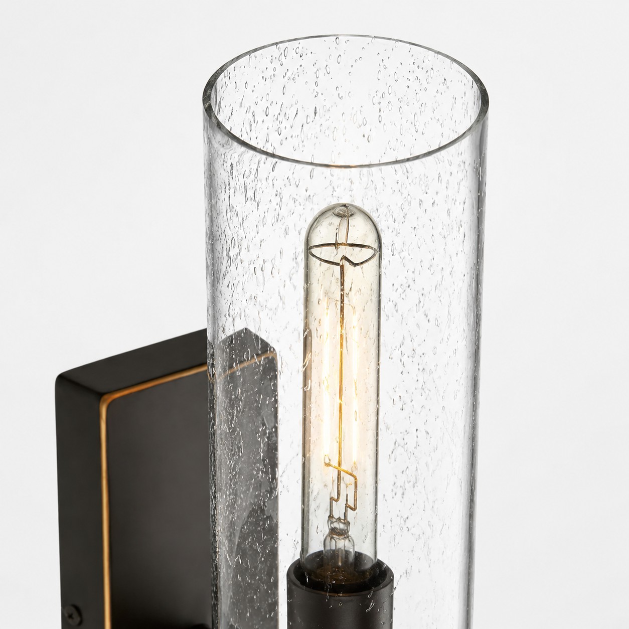 Seeded clear glass wall sconce detail