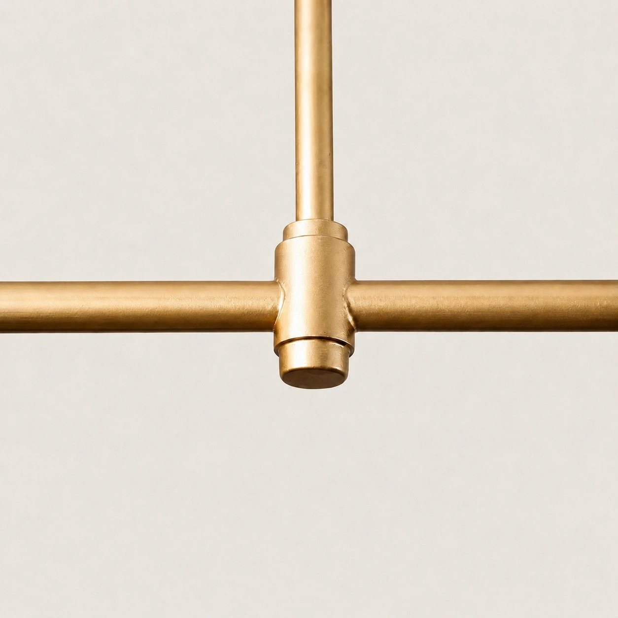 Close-up of Dumora brushed brass T-joint on the linear frame