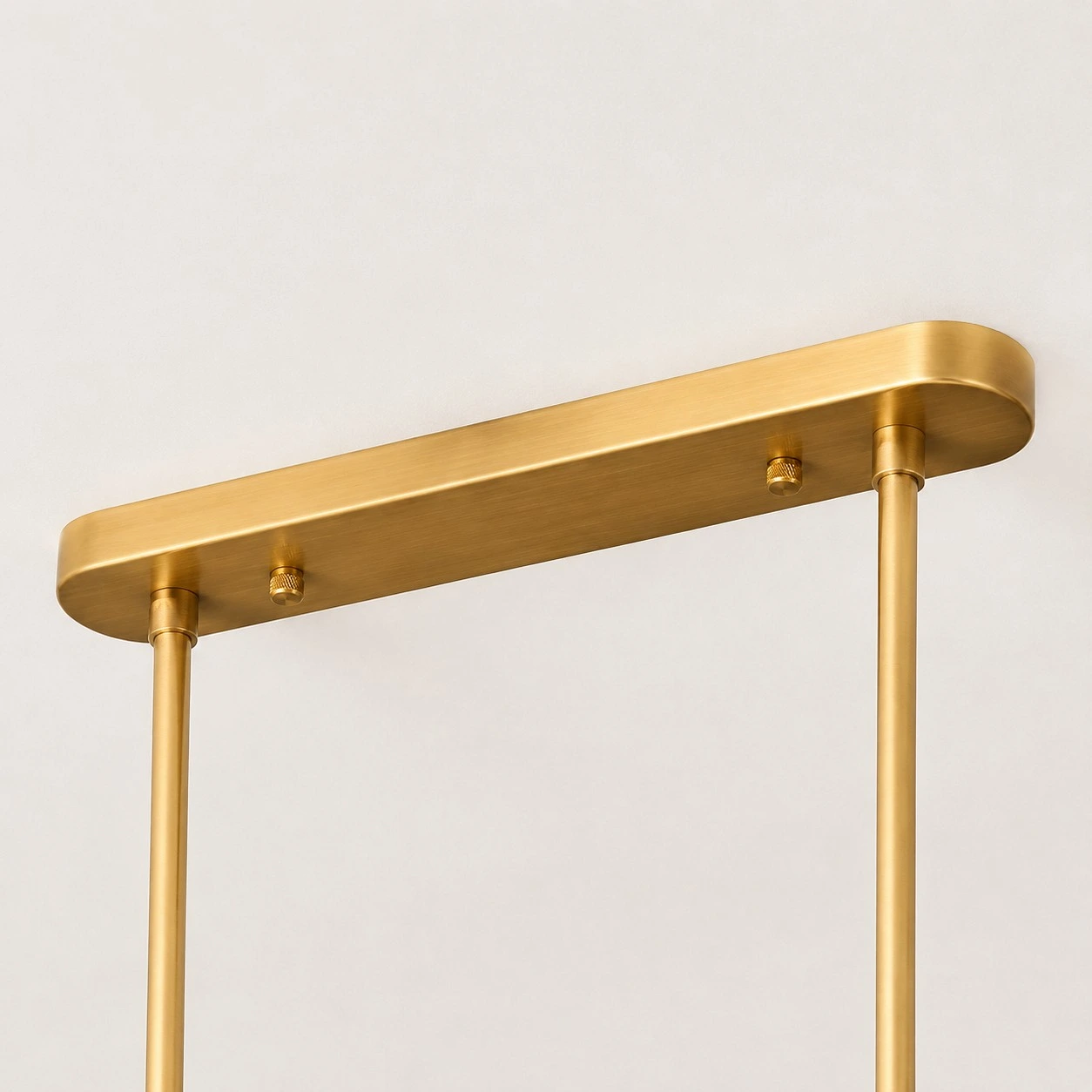 Close-up of Dumora brushed brass rectangular canopy and suspension rods