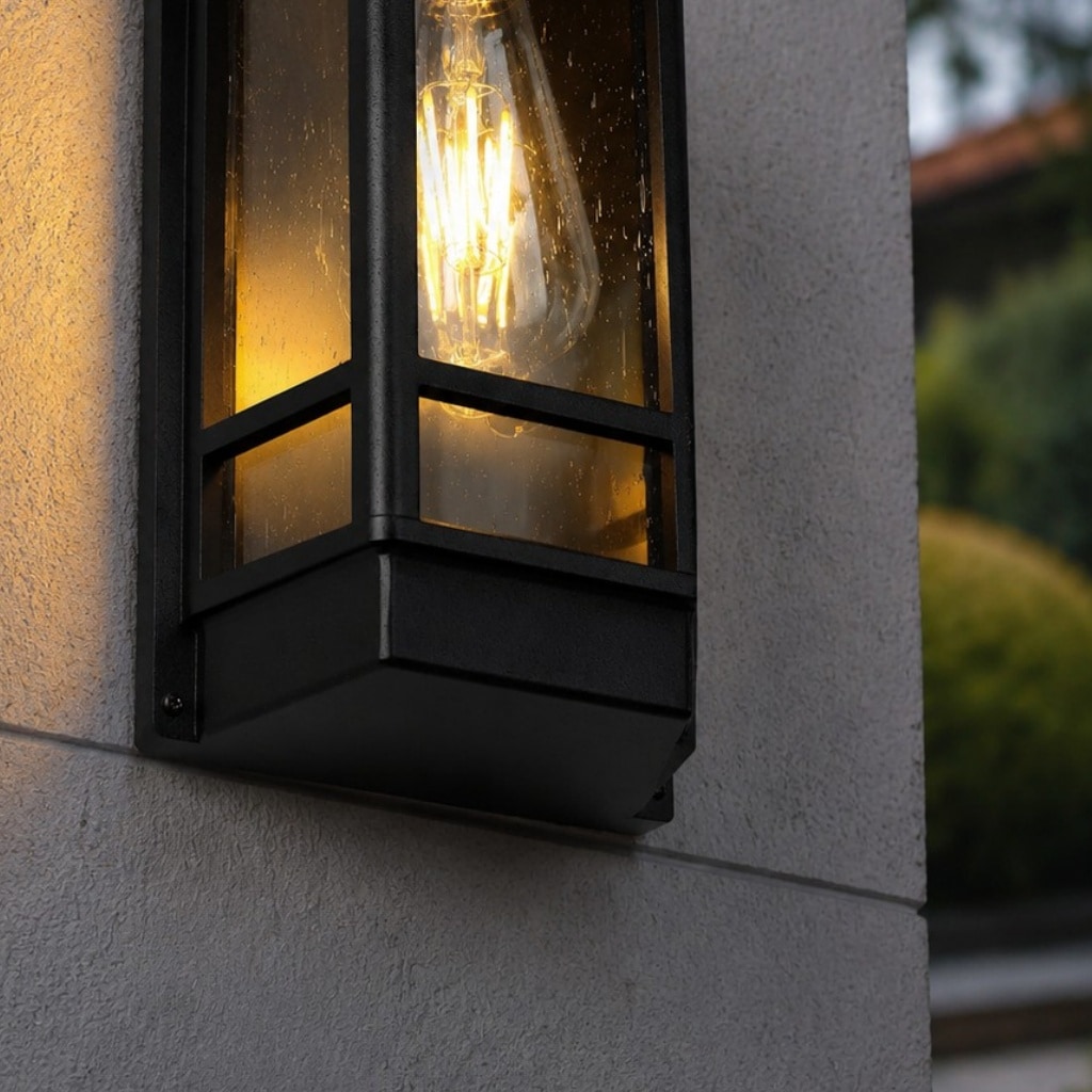 Black outdoor wall sconce lower frame and glass detail
