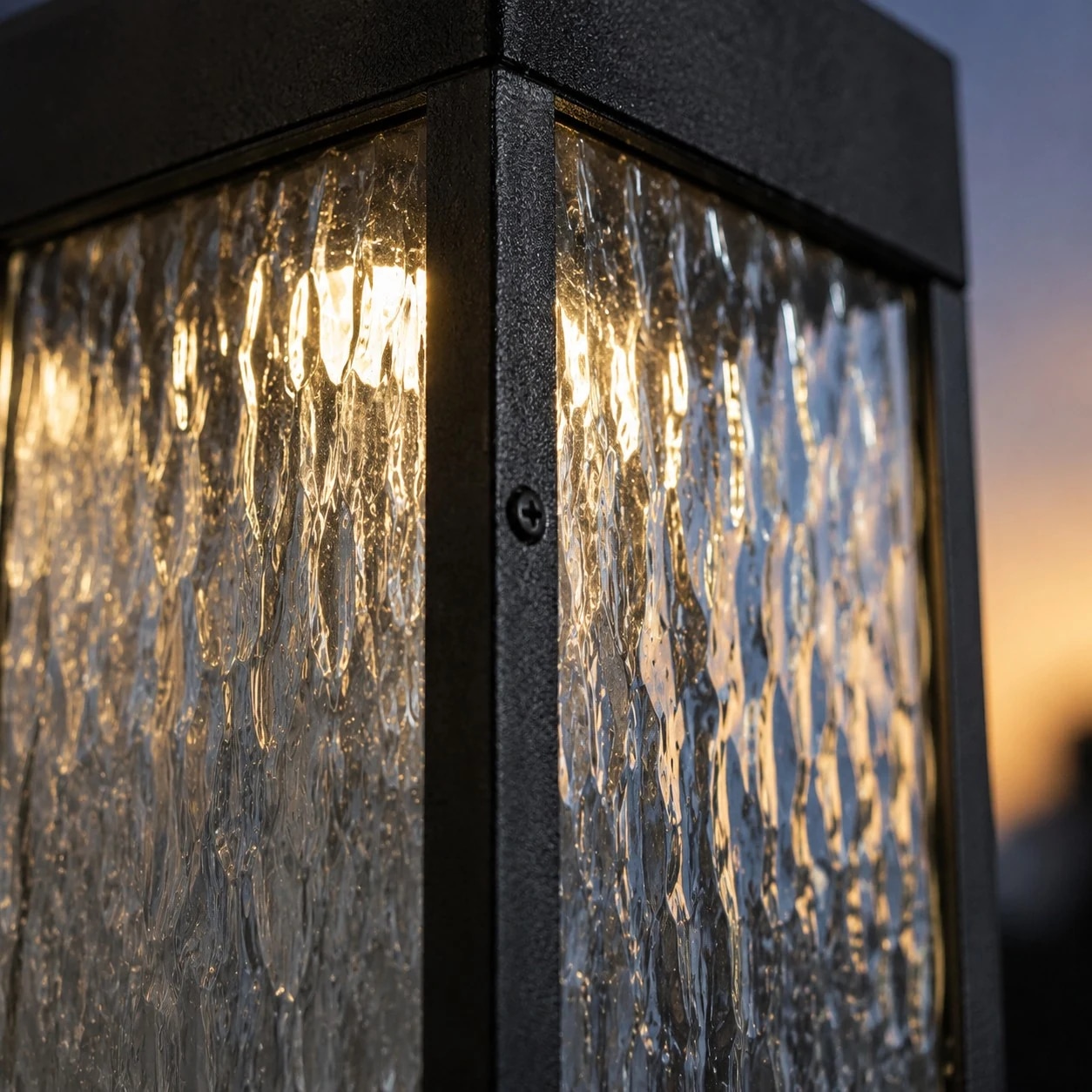 Close-up of rippled clear shade and matte black LED wall light frame