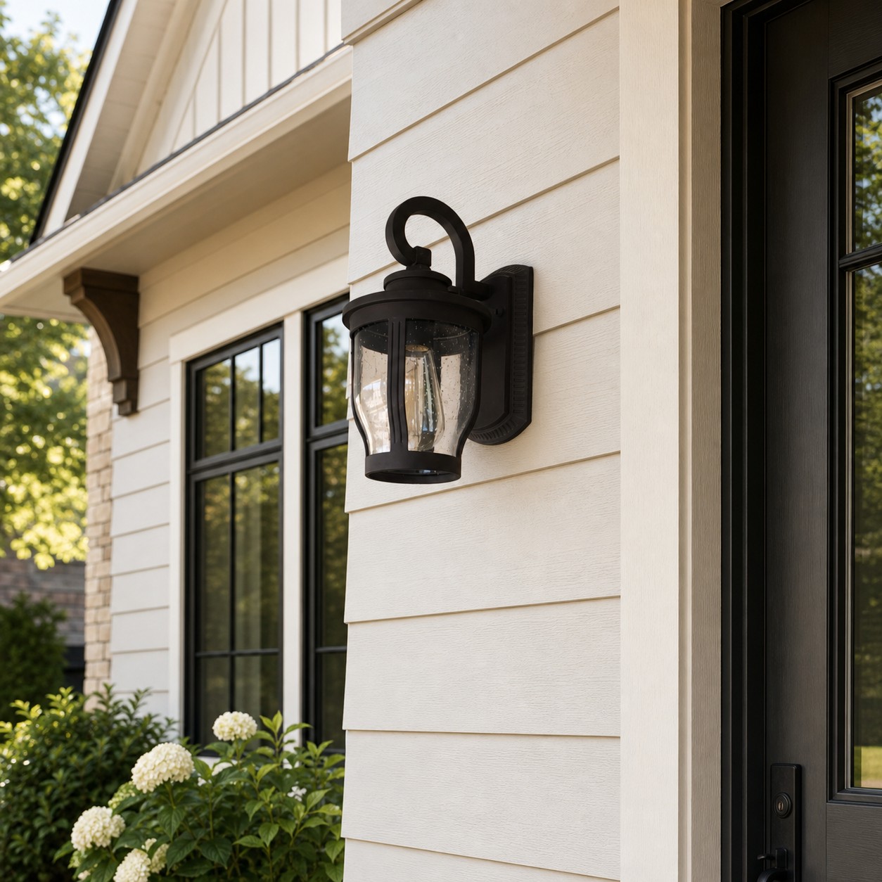 Black rain glass outdoor wall sconce at a residential entry