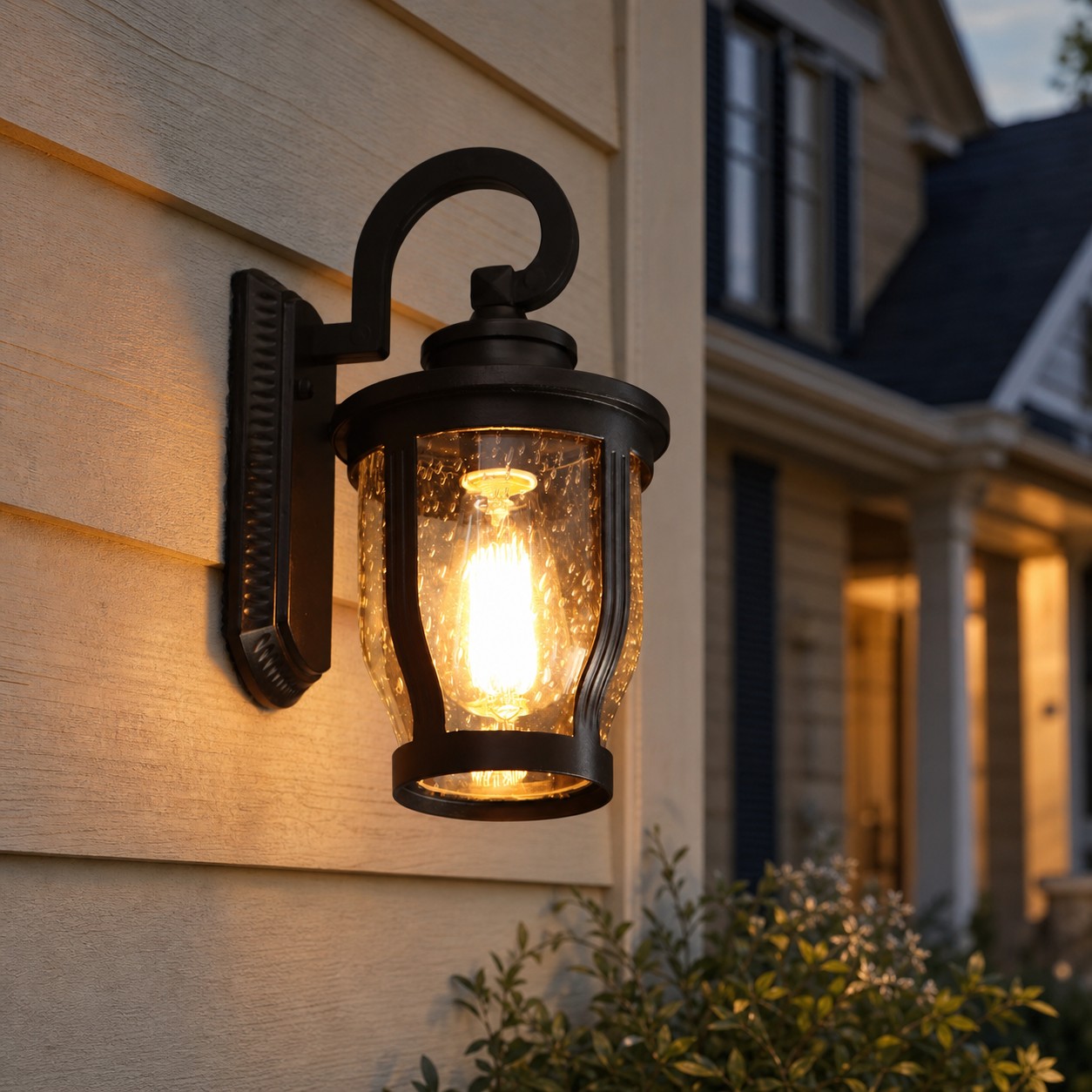 Black rain glass outdoor wall sconce at dusk