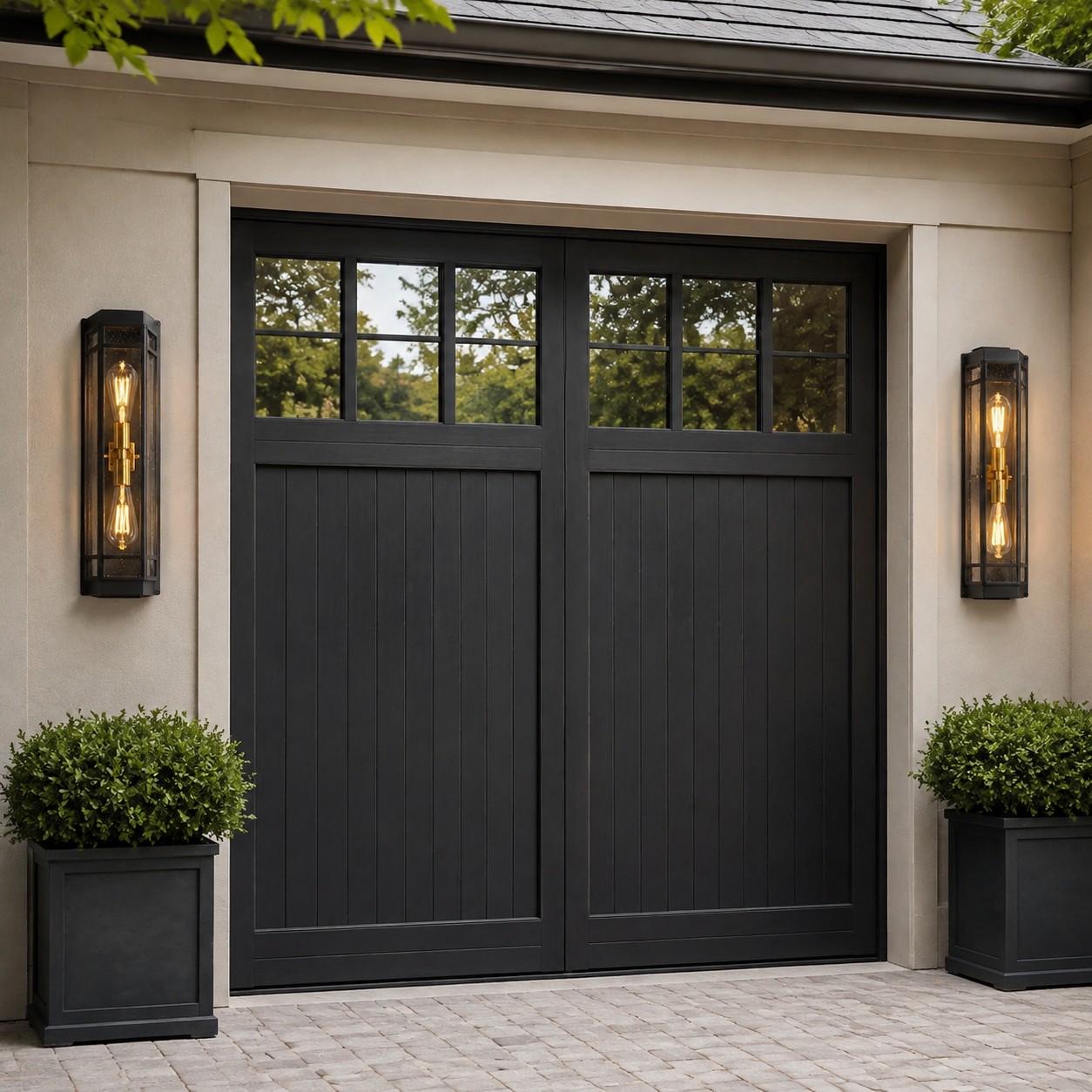 Black glass outdoor wall sconces beside a garage entry