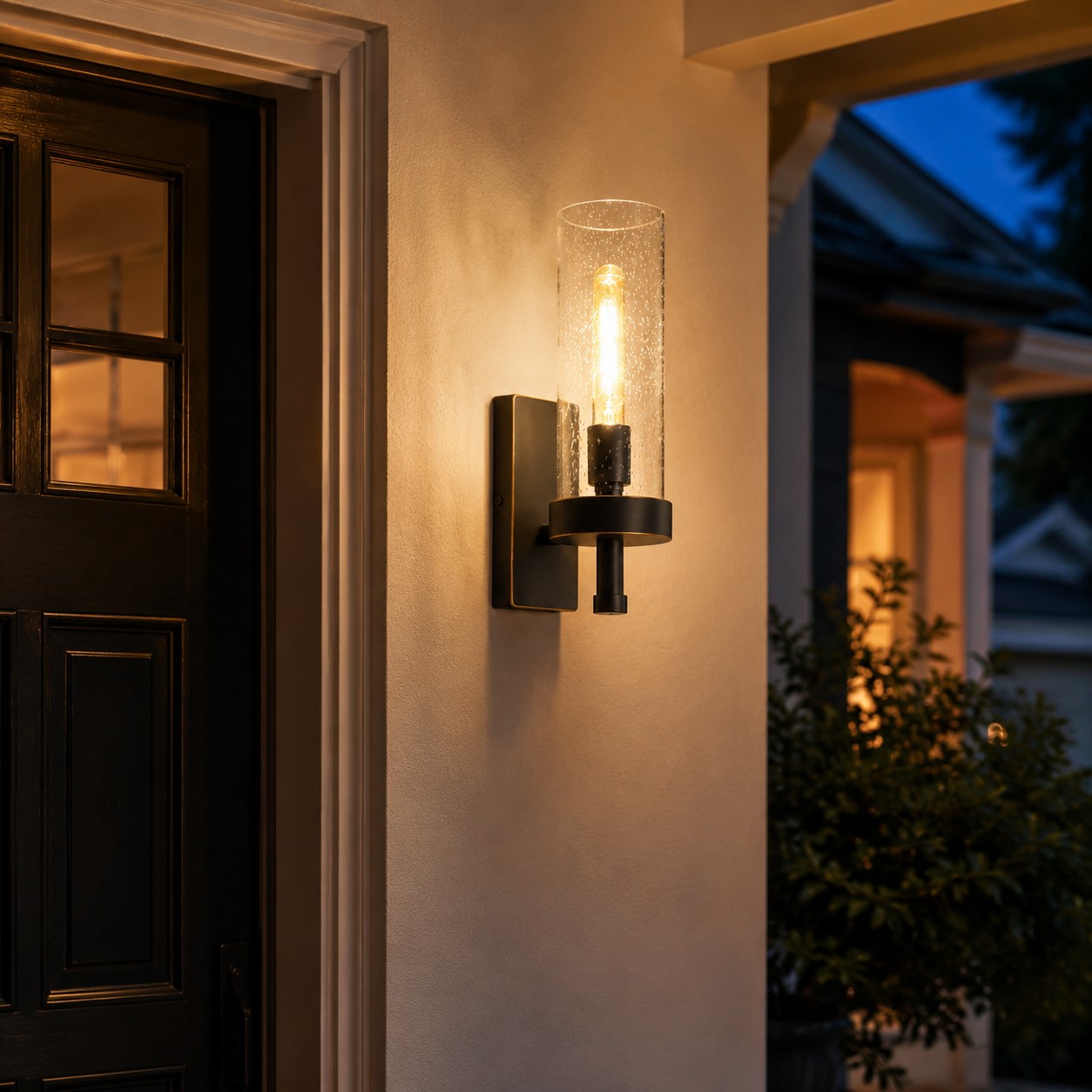 Illuminated wall sconce beside an entry door