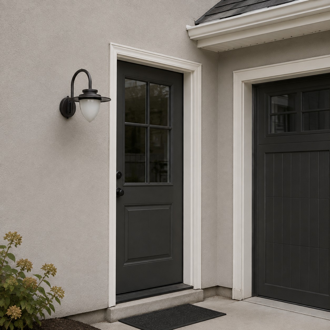 Black outdoor wall lantern at a daytime side entry near a garage