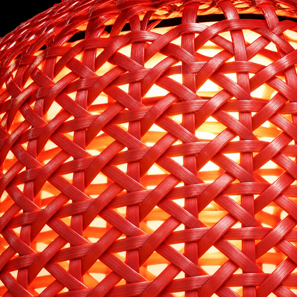 Close-up of terracotta rubber rattan lattice with warm light through the weave