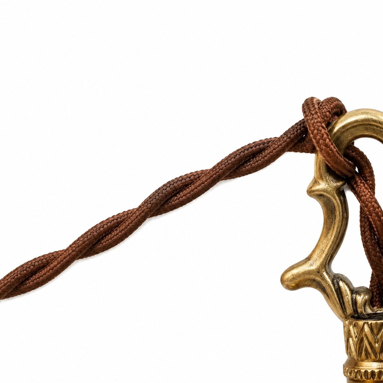 Close-up of the twisted brown fabric cord through the brass hanging loop