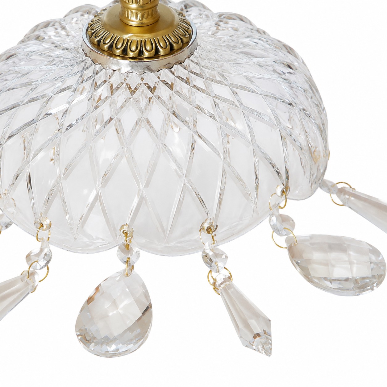 Close-up of diamond-cut clear glass and hanging crystal drops