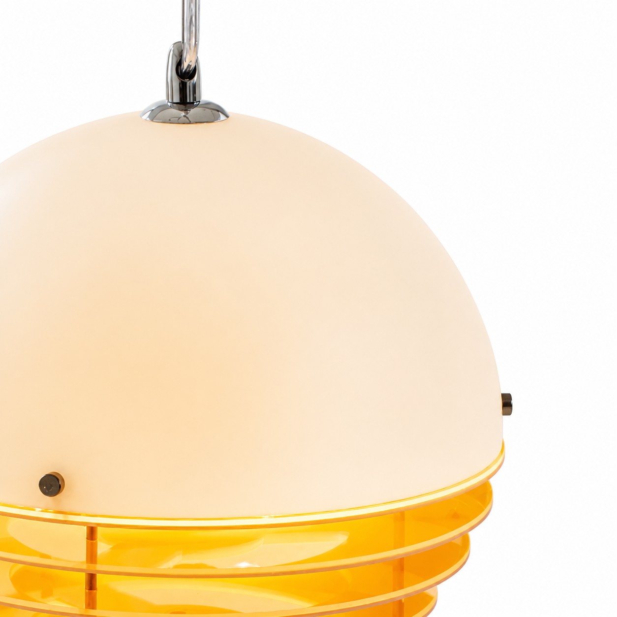 Lit sunset pendant showing a warm glow through the orange rings