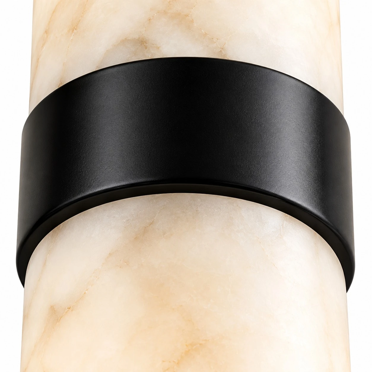 Close-up of translucent alabaster tube with natural veining and metal band